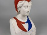 statue of a woman wearing a red hat and blue shirt