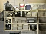 many pots and pans on the shelves in the kitchen