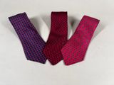 three neck ties on a white surface, one red and one blue