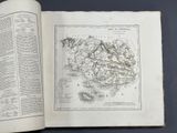 an open book with a map on it sitting on top of a table