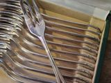 a box with a bunch of forks and spoons in it