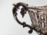 a silver cup that is sitting on top of a table