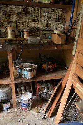une pièce encombrée, avec des outils sur les étagères