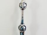 a silver spoon with a knot on it on a table