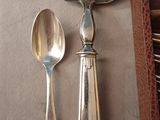 two spoons and a spoon rest on a table