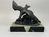 sculpture of a bird on a rock on a white background