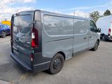 a grey van that is parked in a parking lot