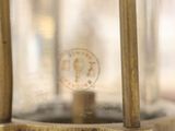 a close up of a brass colored lamp on a table