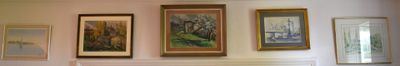 a blurry picture of a living room with paintings on the wall