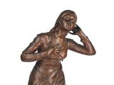 bronze statue of a woman talking on a cell phone