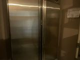 a large stainless steel refrigerator in the corner of a room