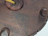 a close up of a clock with a yellow handle