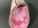 an image of a pink purse with a gold zipper on it