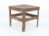 a small wooden table with a metal frame on it