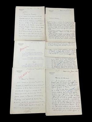 four old papers with handwriting on them sitting on top of a table