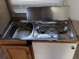 a small kitchen with a stove and sink in it