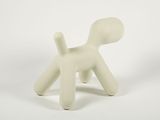 a small white dog that is sitting on a white surface