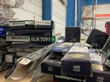 boxes of electronic equipment are stacked on a table in a warehouse