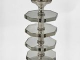 a glass candle holder with a candle on it