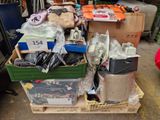 a pile of boxes and other items on a pallet in a garage