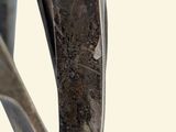 a close up of a metal object on a white background