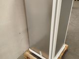 a refrigerator that is sitting on a pallet in a room