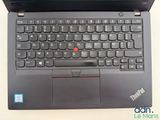 a black laptop with a red button on the keyboard