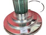 a green blender sitting on top of a red plate