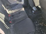 a dirty seat in the back of a car