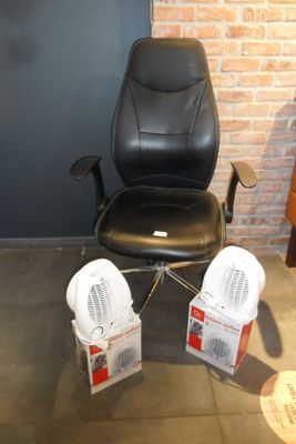 a black office chair that is sitting in front of a brick wall