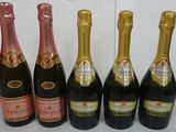 six bottles of champagne are lined up in a row on a table