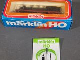 a box of marklin ho train cars on a table