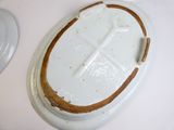 a white plate with a brown edge and a white plate with a brown edge