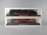 two model trains sitting on display in a box