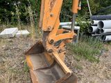 a small excavator that is sitting in the grass