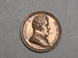 a close up of a coin with a man ' s face on it
