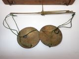 two bells hanging on a wall next to a piece of wood