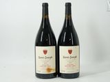 two bottles of wine sitting next to each other on a table
