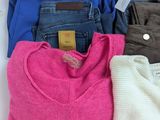 three pairs of women ' s sweaters and jeans laid out on a white surface