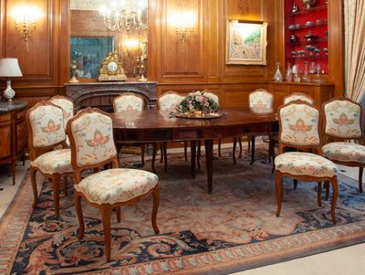 a dining room with a table and chairs and a chandelier
