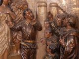 a statue of a group of people standing in front of a wall