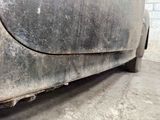 a dirty car that is parked in a garage