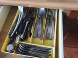 a drawer full of utensils and spoons in it