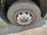 a person standing next to a car that has a flat tire on it