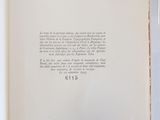 an open book on a white sheet with a picture of a cat