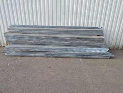 a pile of galvaniized steel bars in front of a building