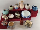 many different types of vases and bowls on the table