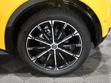 a close up of a yellow car with black rims