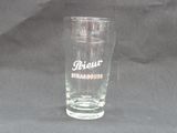a shot of a beer glass with the word breut on it