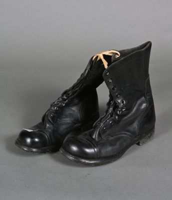an old pair of black boots with laces on them